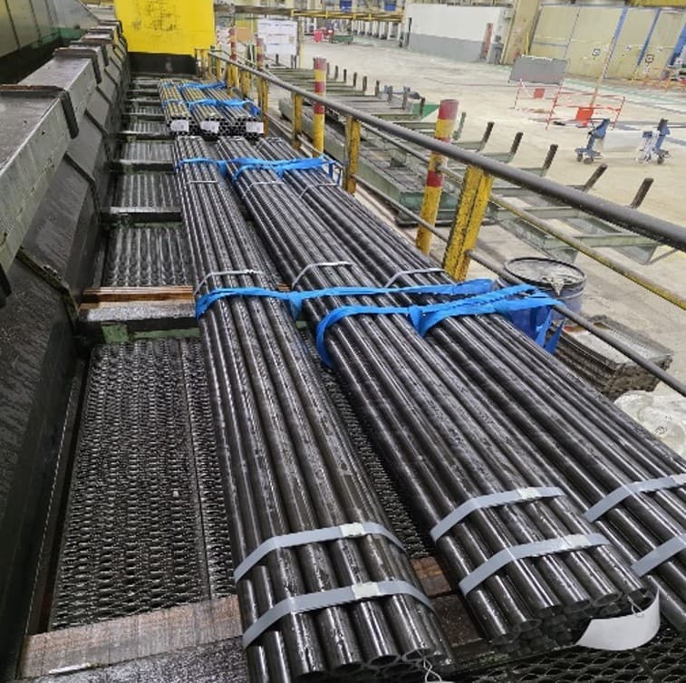 Seamless precision steel tubes bundled on the production floor — the industrial context of the project